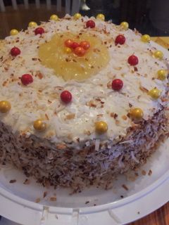 A picture of Pineapple filled toasted coconut yellow rum cake..