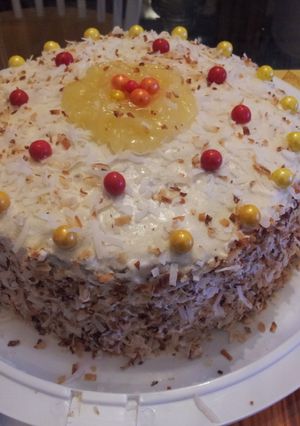 A picture of Pineapple filled toasted coconut yellow rum cake..