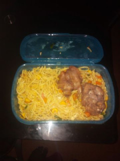 A picture of Spagetti with carrots and chicken.