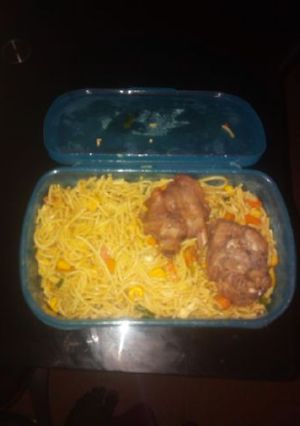 A picture of Spagetti with carrots and chicken.