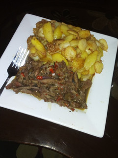 A picture of Fried potatoes with beef sauce.