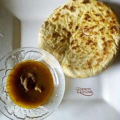 A picture of Pita bread and beef pepper soup.