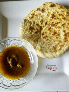 A picture of Pita bread and beef pepper soup.