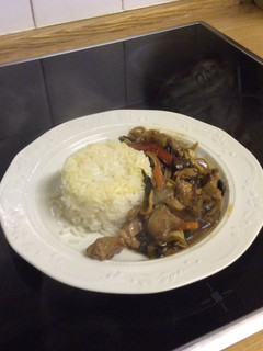 A picture of Stir Fried Pork with stir fried vegetables and white rice.