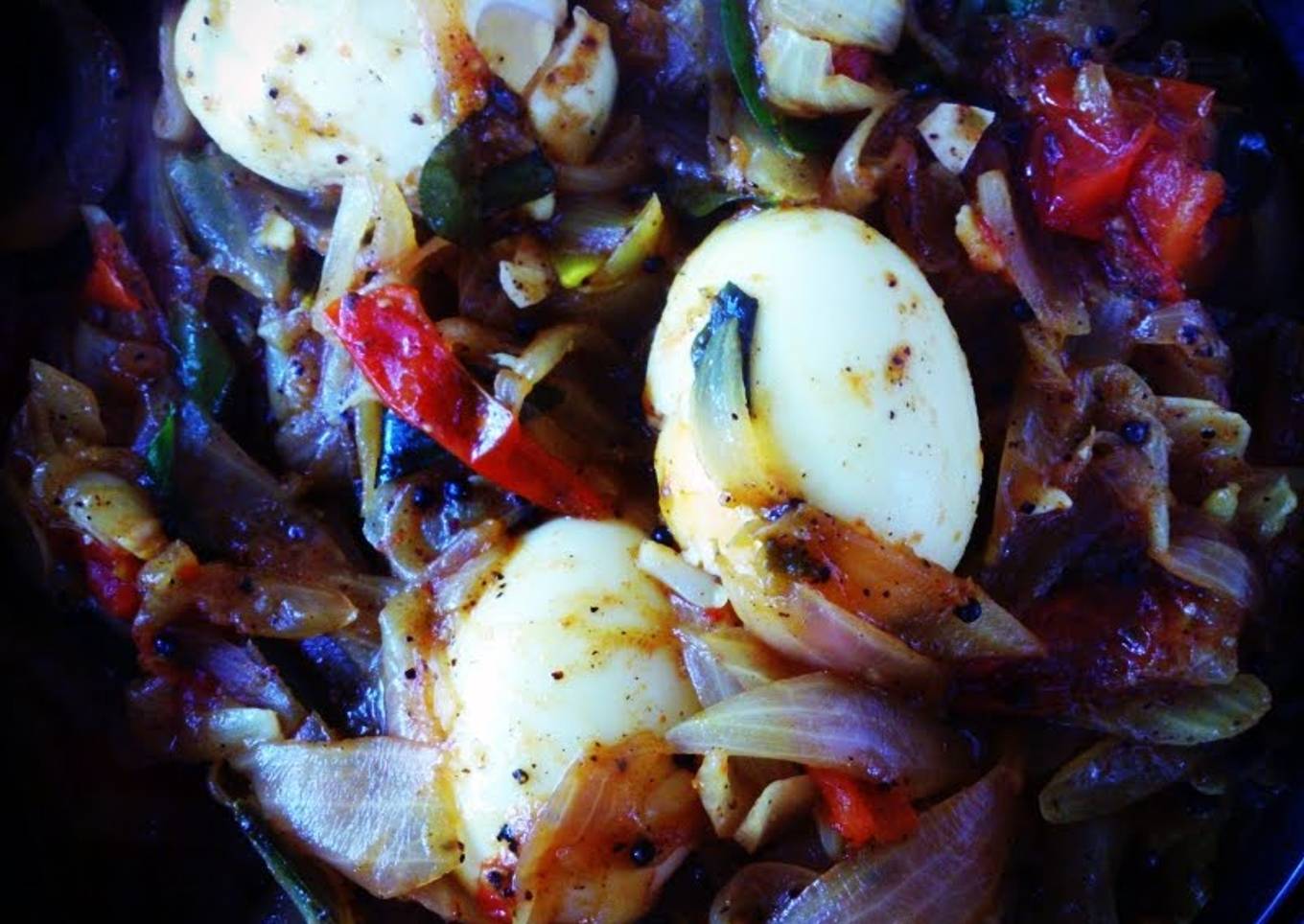 Jake's Eggs in a roast with onion and tomatoes