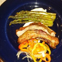 A picture of Sticky Asian pork ribs with grilled asparagus over red wine feta aioli.