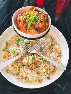 A picture of Chilli Chicken with egg fried Rice.