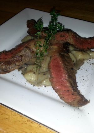 A picture of creamy mushrooms gnocchi with wagyu beef.