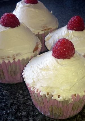 A picture of raspberry / blueberry / chocolate chip / cola bottle cupcakes.