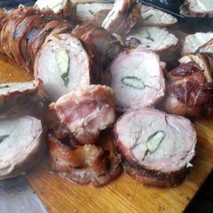 Pork tenderloin stuffed with herbs and garlic, wrapped in bacon A picture of Pork tenderloin stuffed with herbs and garlic, wrapped in bacon.