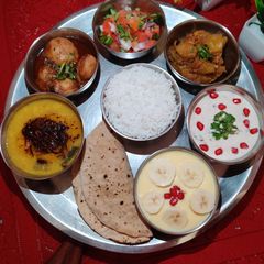 A picture of NORTH INDIAN THALI for Lunch..Dal, Aloo Dum, Kaddu sabzi, Rice, Roti, Raita, Salad, Custard..