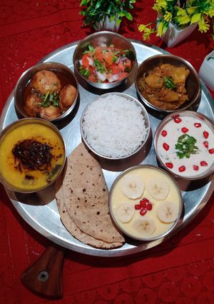 A picture of NORTH INDIAN THALI for Lunch..Dal, Aloo Dum, Kaddu sabzi, Rice, Roti, Raita, Salad, Custard..
