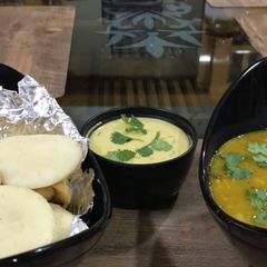 A picture of Soft Rava Idli with sambar and coconut chutney.