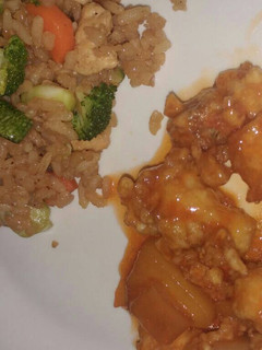 A picture of Fried Chinese Rice and Sweet and Sour Chicken.