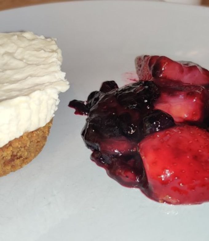 A picture of Vanilla cheese cake and berry compote.