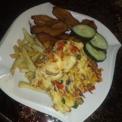 A picture of Chips, fried plantain and egg.