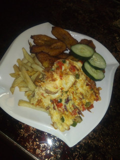 A picture of Chips, fried plantain and egg.