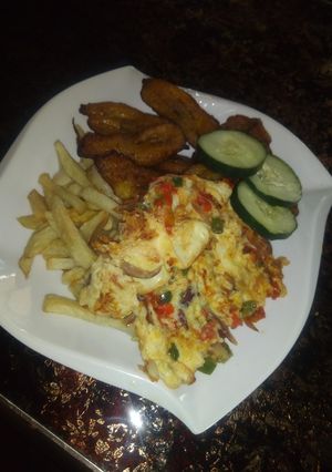 A picture of Chips, fried plantain and egg.