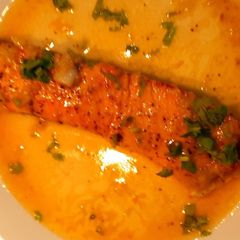 A picture of Salmon in lemon butter sauce.