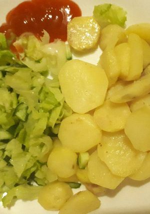 A picture of Fried potatoes and salad.