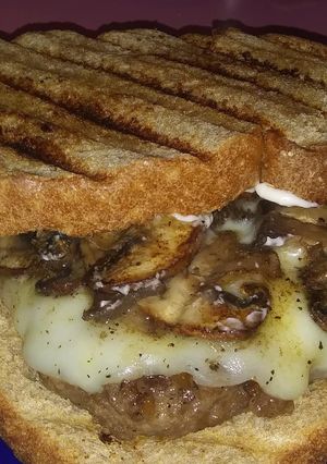 A picture of French onion and Swiss burgers.