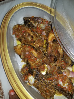 A picture of Peppered fresh fish with onion garnish.