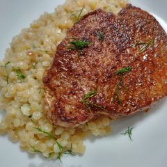 A picture of Pumpkin-spiced pork chops and couscous.