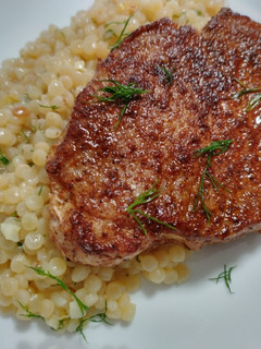 A picture of Pumpkin-spiced pork chops and couscous.
