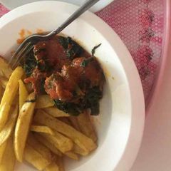 A picture of Fried potatoes with vegetable sauce.