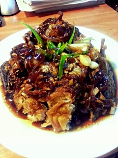 A picture of black sauce fried fish.