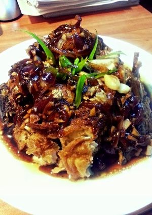A picture of black sauce fried fish.