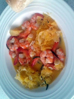 A picture of Prawns in orange sauce.