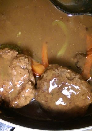 A picture of Burgers in gravy.