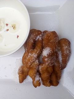 A picture of Rasmalai and twisted doughnut.