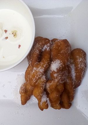 A picture of Rasmalai and twisted doughnut.