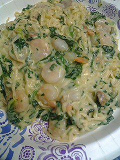 A picture of Spinach shrimp alfredo with noodles.