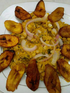 A picture of Black eyed beans with corn pudding, garnished with basilica leaf.