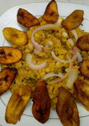 A picture of Black eyed beans with corn pudding, garnished with basilica leaf.