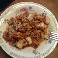 A picture of Rice, chicken, potatoes and Sauteéd veggies in soy sauce.