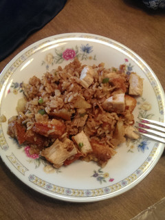 A picture of Rice, chicken, potatoes and Sauteéd veggies in soy sauce.