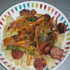 A picture of Macaroni with pan fried smoked beef sausage and stirfry veg.