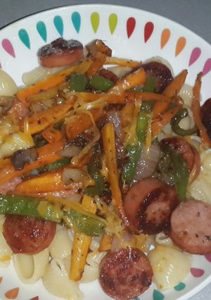 A picture of Macaroni with pan fried smoked beef sausage and stirfry veg.