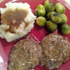 A picture of Salisbury steak and onion gravy.