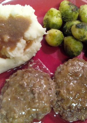 A picture of Salisbury steak and onion gravy.