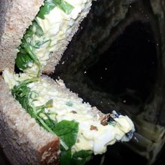 A picture of Egg Salad and Arugula Sandwhich.