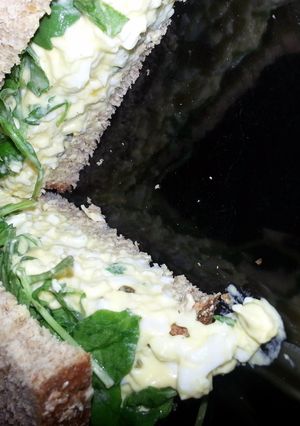 A picture of Egg Salad and Arugula Sandwhich.