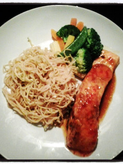 A picture of sweet chilli salmon with noodles.