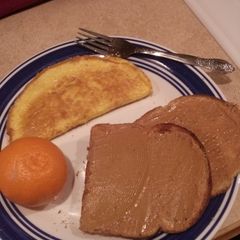 A picture of Ham and Cheese Omelet with Toast and Fruit.