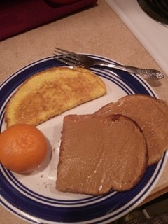 A picture of Ham and Cheese Omelet with Toast and Fruit.