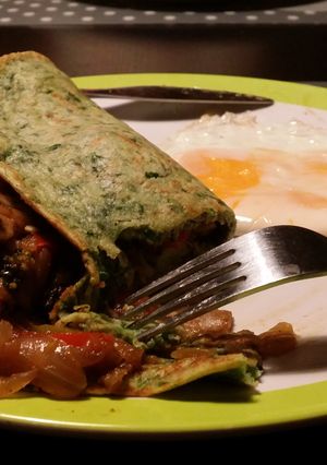 A picture of Spinach pancakes stuffed with veggies.